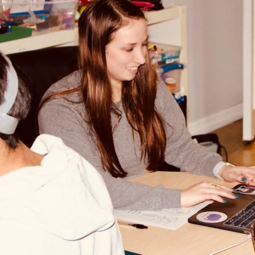 Young woman working on a laptop indoors.