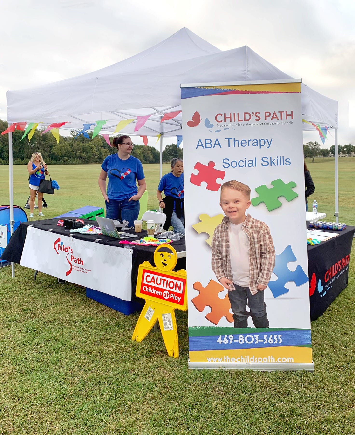 Child-friendly autism awareness booth with activities and information.