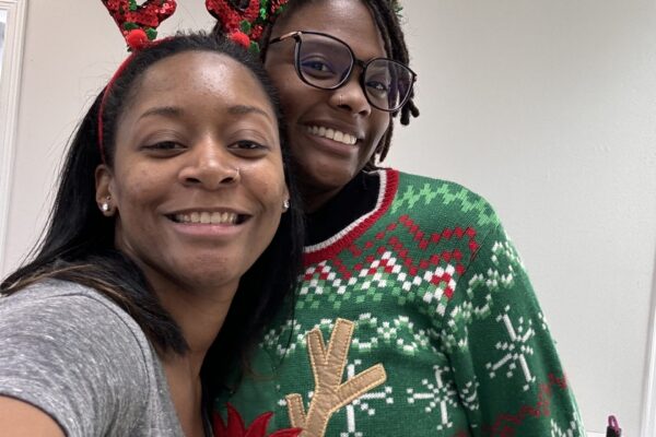 Two people wearing festive holiday attire.